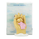 Protective angel with baby in hand
