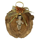 Statue of baby Jesus on dry leaf